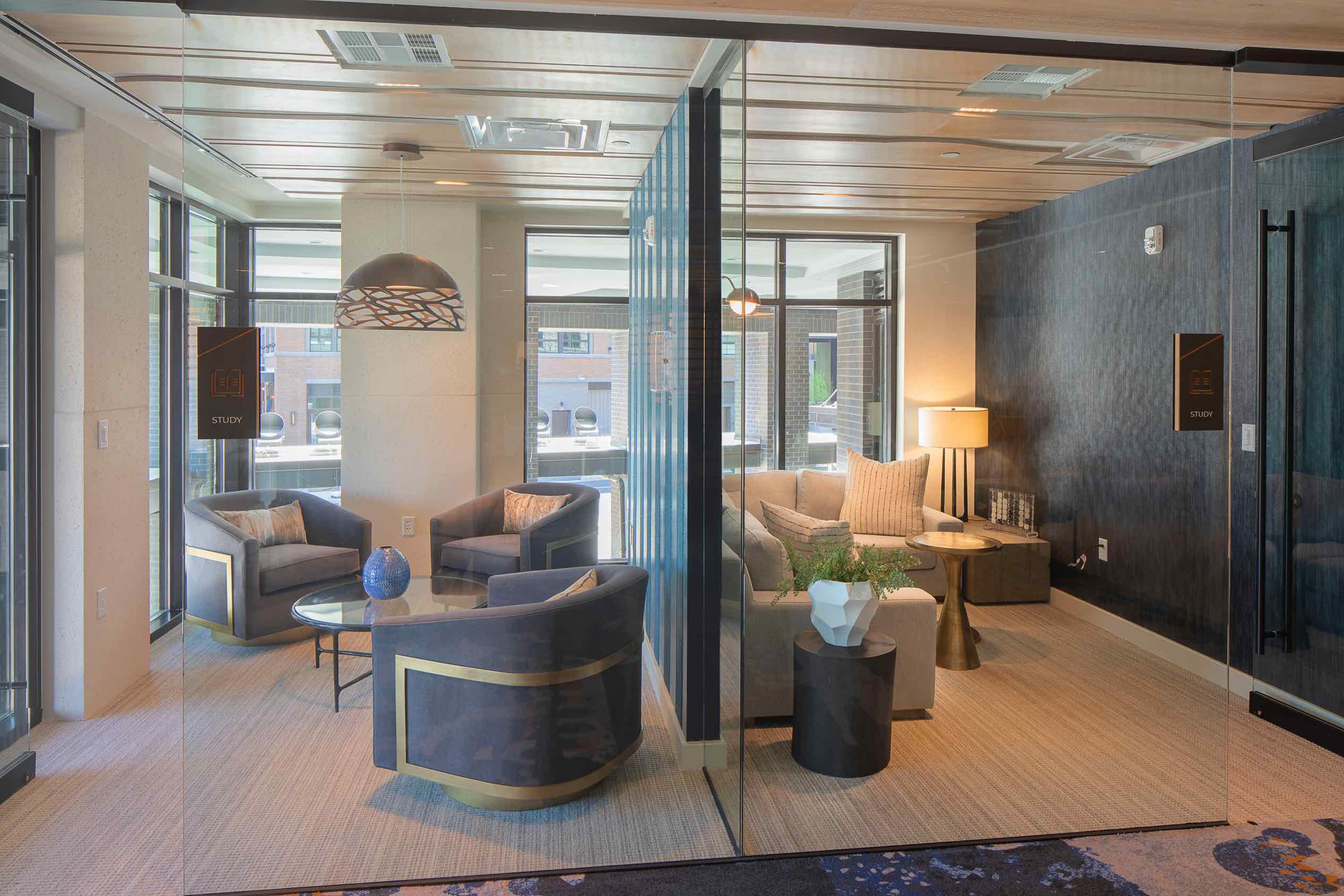 Meeting rooms with glass walls & comfortable couches. One of the amenities of 250 Mission in Baltimore, MD.