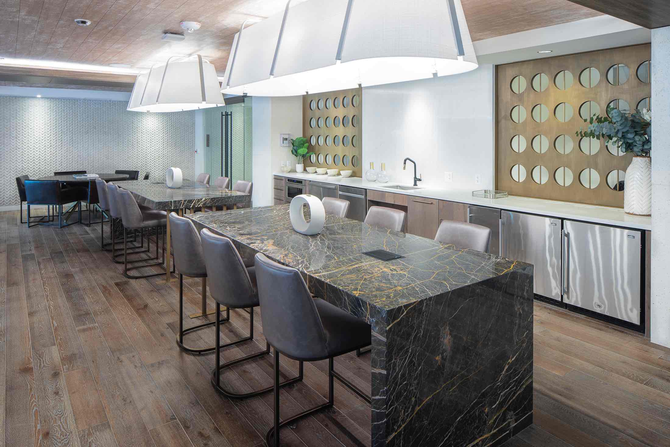Clubroom bar lounge with marble countertops & plush seating. One of the amenities of 250 Mission in Baltimore, MD.