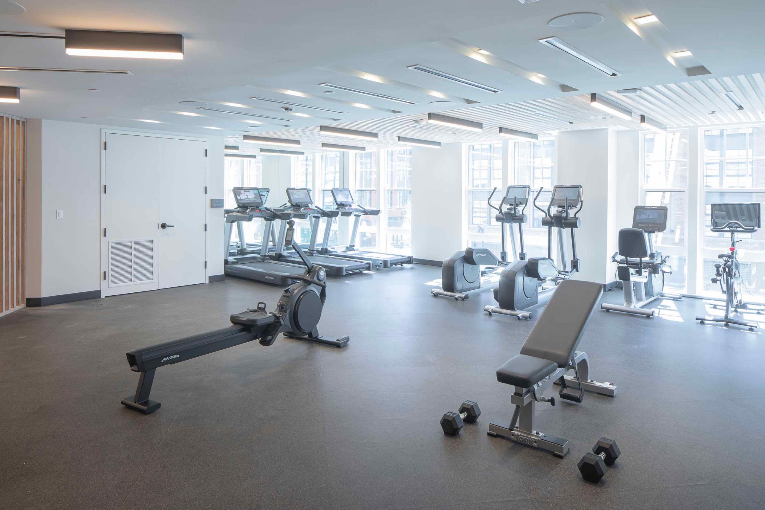 A fitness center with tread machines and exercise equipment. One of the amenities of 250 Mission in Baltimore, MD.